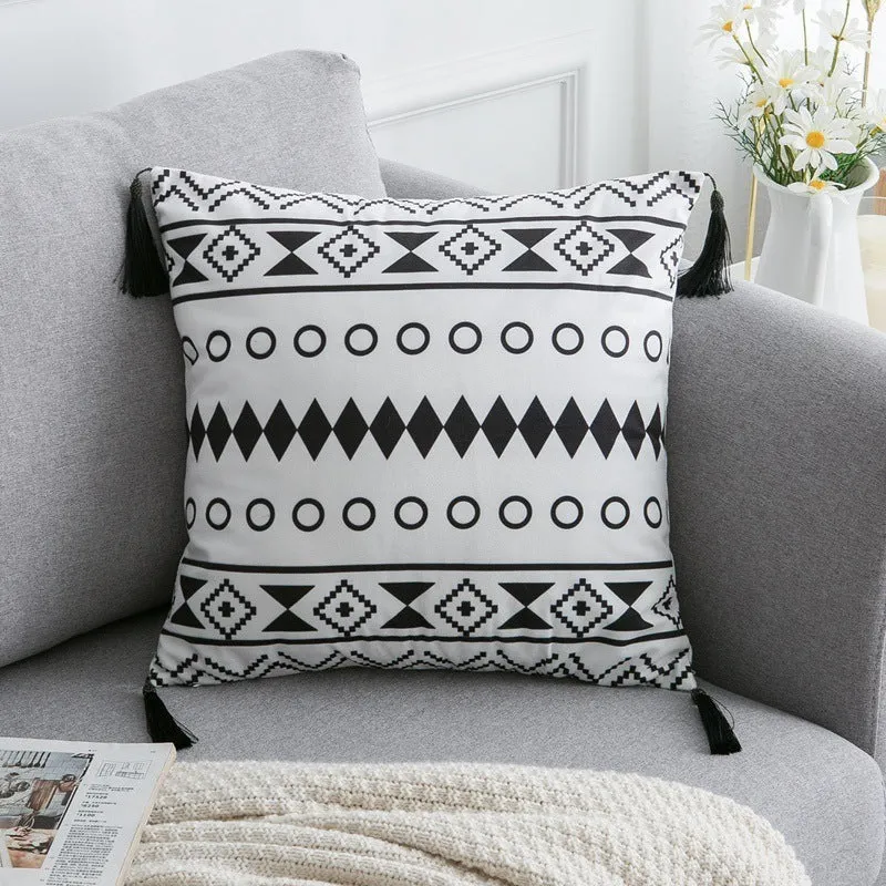 Bohemian national style throw pillow cushion cover in light grey on a sofa.