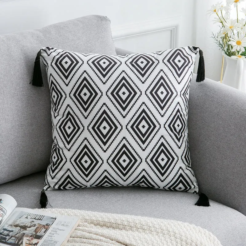 Bohemian national style throw pillow cushion cover in light grey on a sofa.
