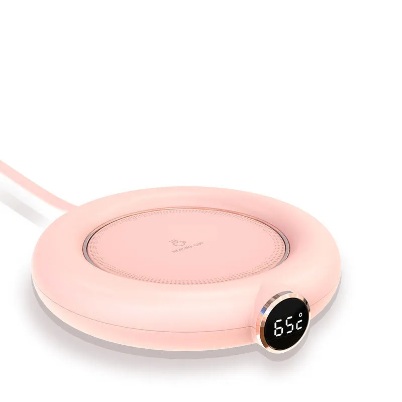 White USB cup warmer pad on desk with LED display showing temperature setting and mug on top