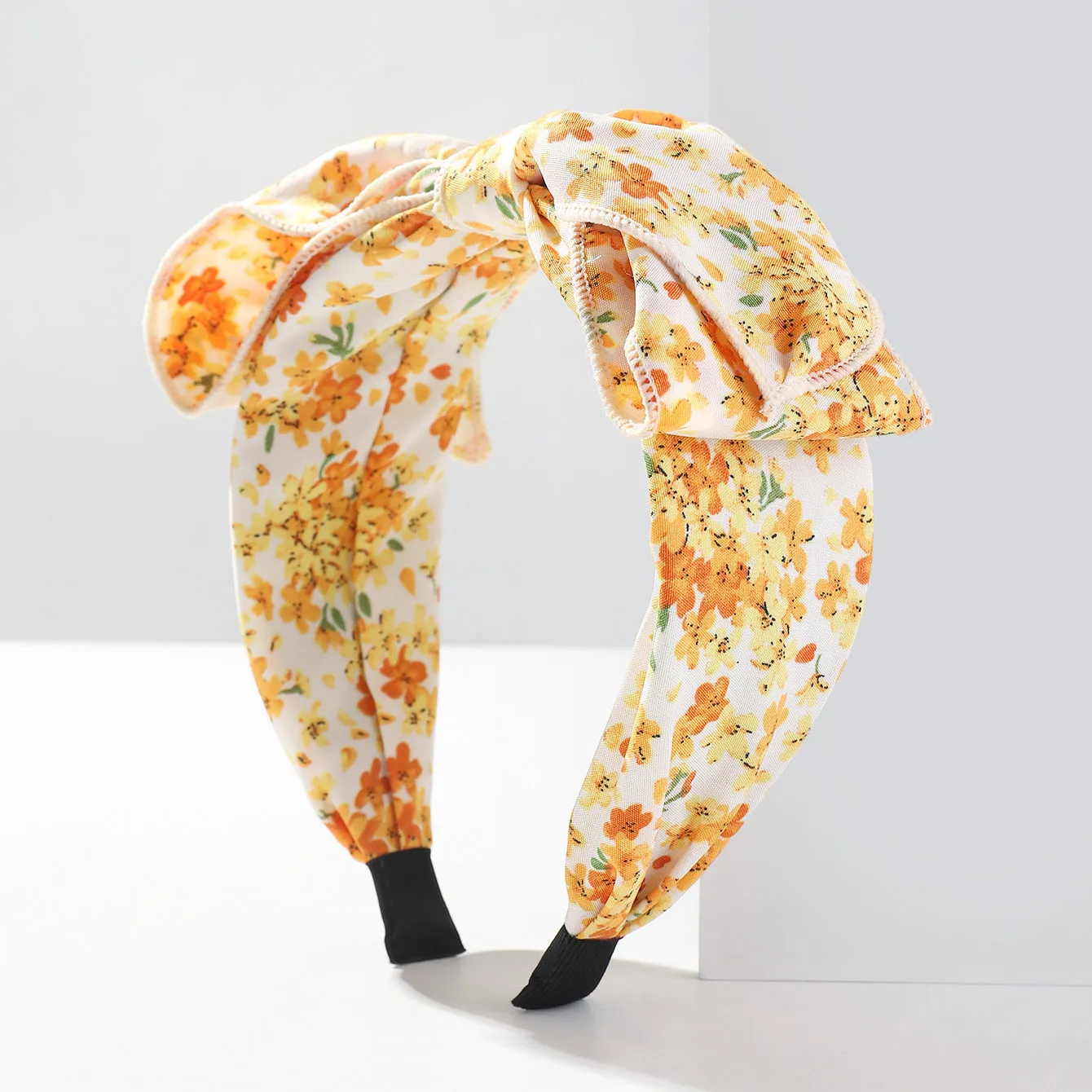 Handmade cloth hair bow with printed orchid and daisy flowers in pastoral style for women