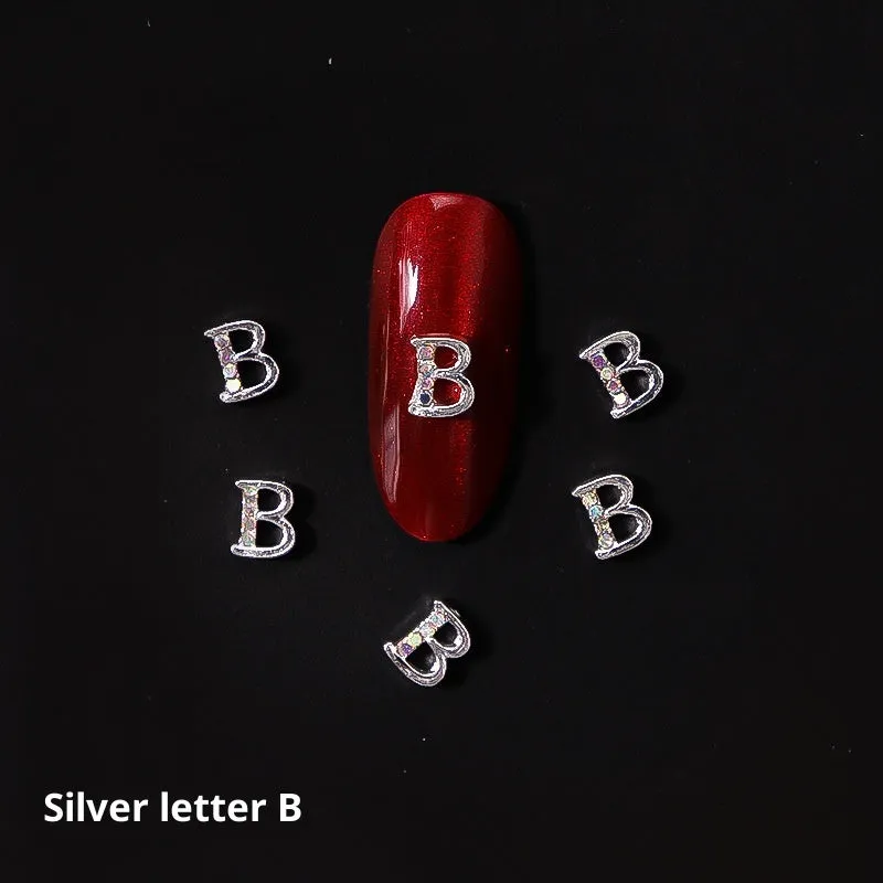 Gold alloy letter A nail ornament charm with crystal detail on a square chain base