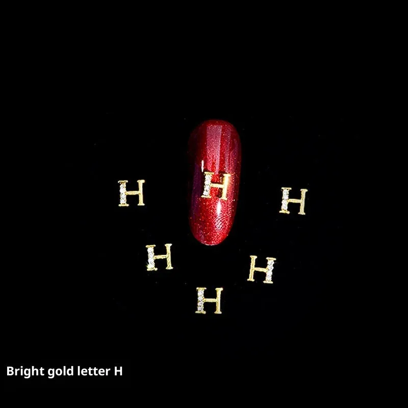 Gold alloy letter A nail ornament charm with crystal detail on a square chain base