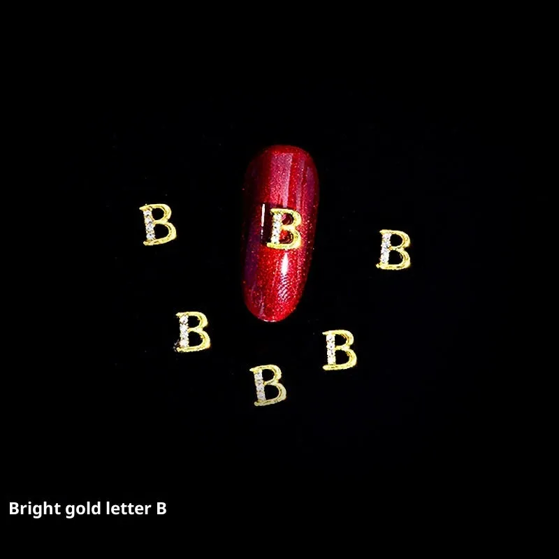 Gold alloy letter A nail ornament charm with crystal detail on a square chain base