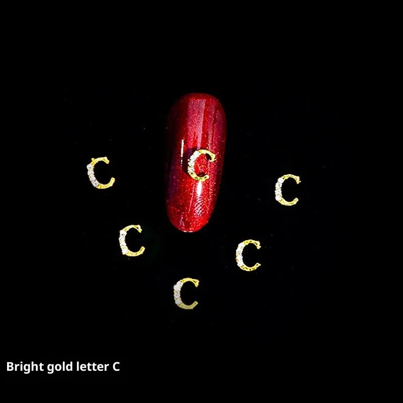 Gold alloy letter A nail ornament charm with crystal detail on a square chain base