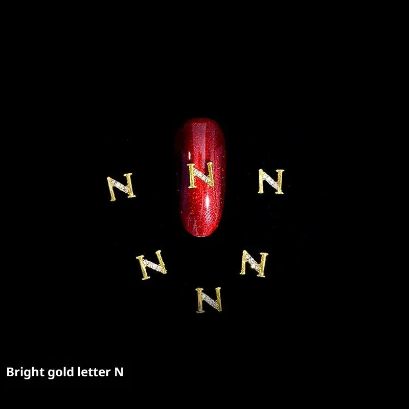 Gold alloy letter A nail ornament charm with crystal detail on a square chain base