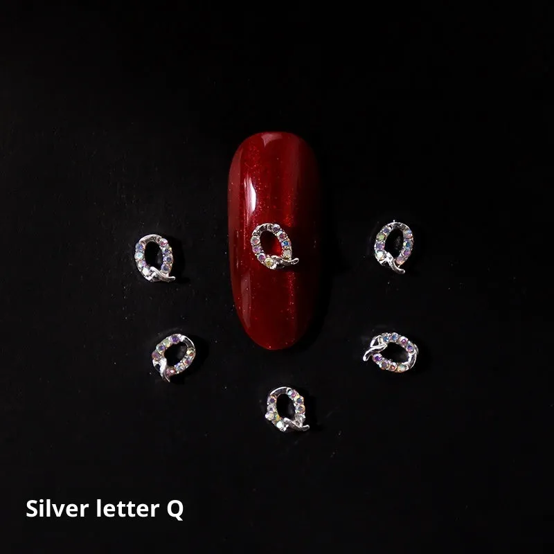 Gold alloy letter A nail ornament charm with crystal detail on a square chain base