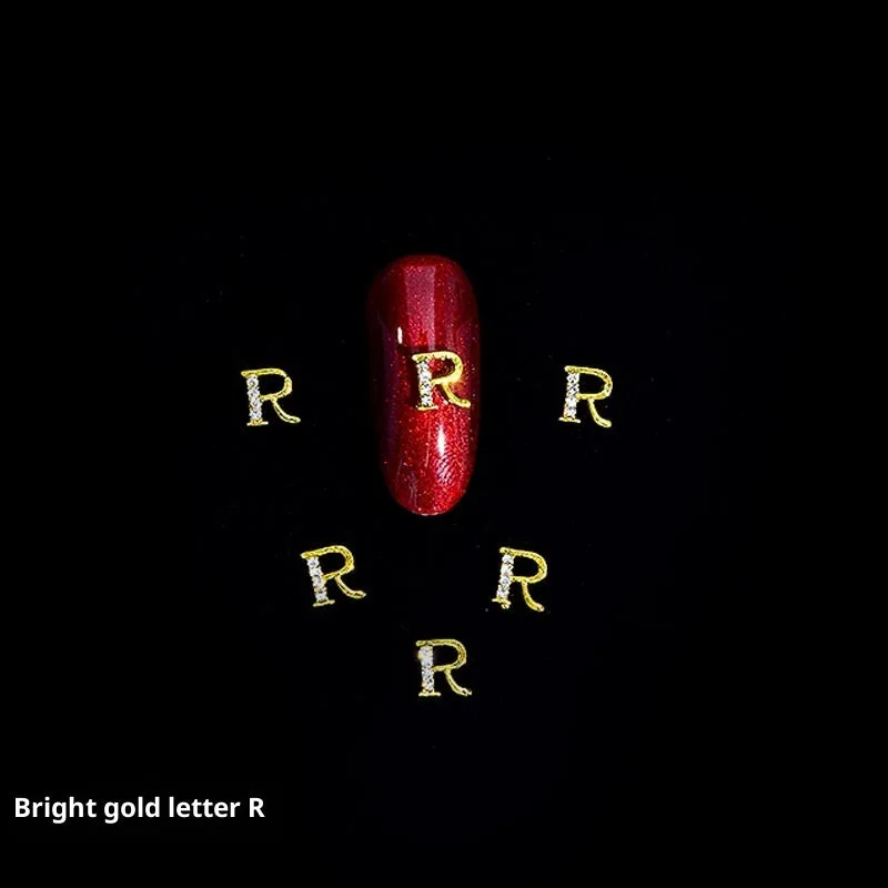 Gold alloy letter A nail ornament charm with crystal detail on a square chain base