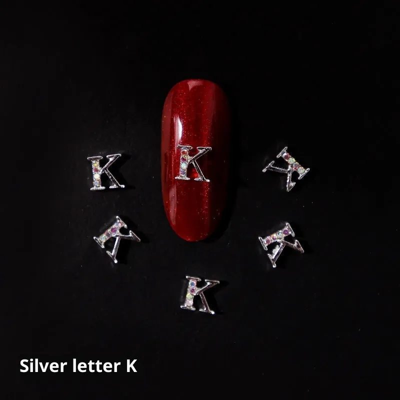 Gold alloy letter A nail ornament charm with crystal detail on a square chain base