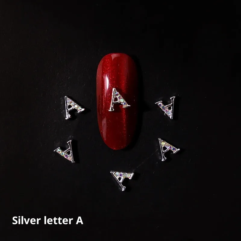 Gold alloy letter A nail ornament charm with crystal detail on a square chain base