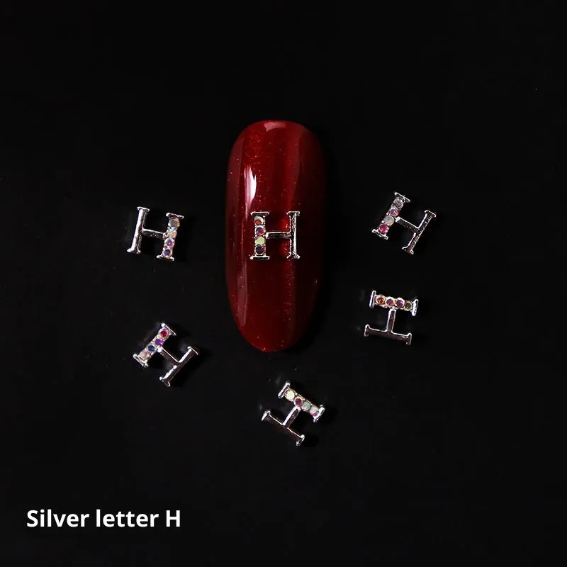 Gold alloy letter A nail ornament charm with crystal detail on a square chain base