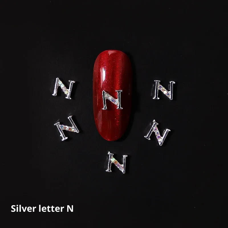 Gold alloy letter A nail ornament charm with crystal detail on a square chain base