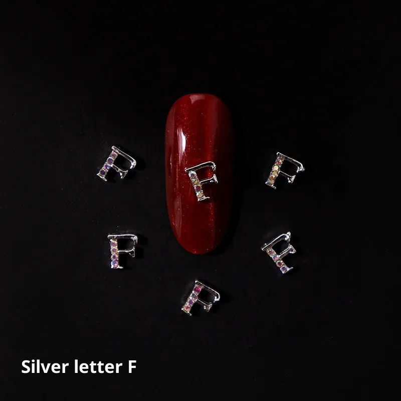 Gold alloy letter A nail ornament charm with crystal detail on a square chain base