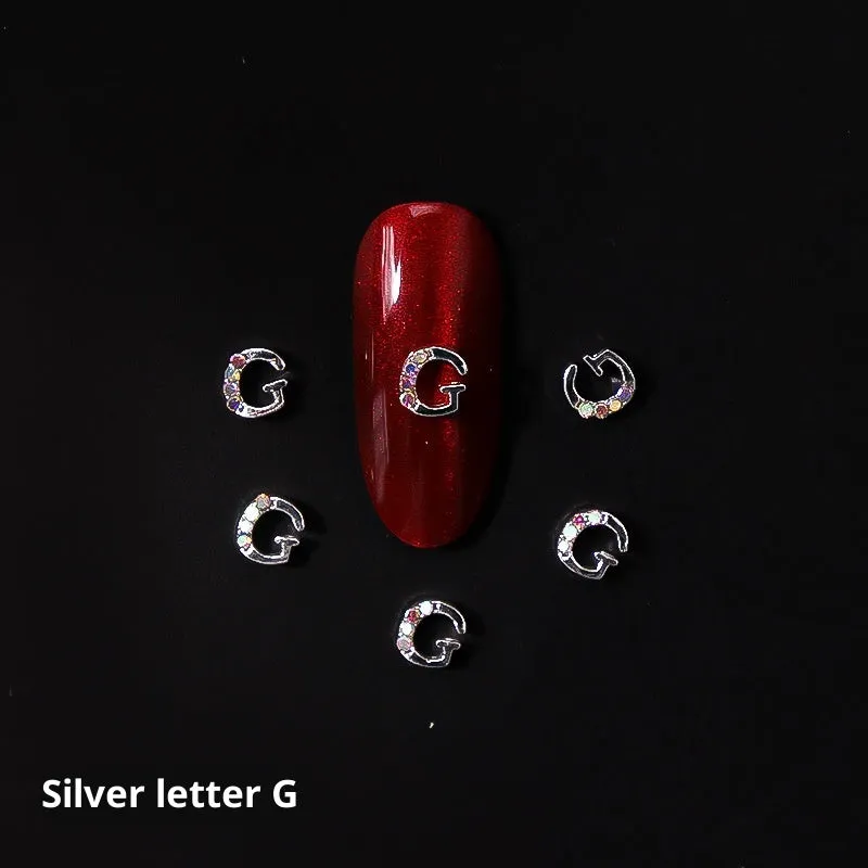 Gold alloy letter A nail ornament charm with crystal detail on a square chain base