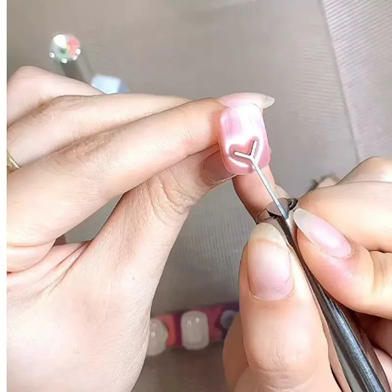 Cylindrical metal nail art magnet and Y-shaped bracket for cat eye gel polish designs.