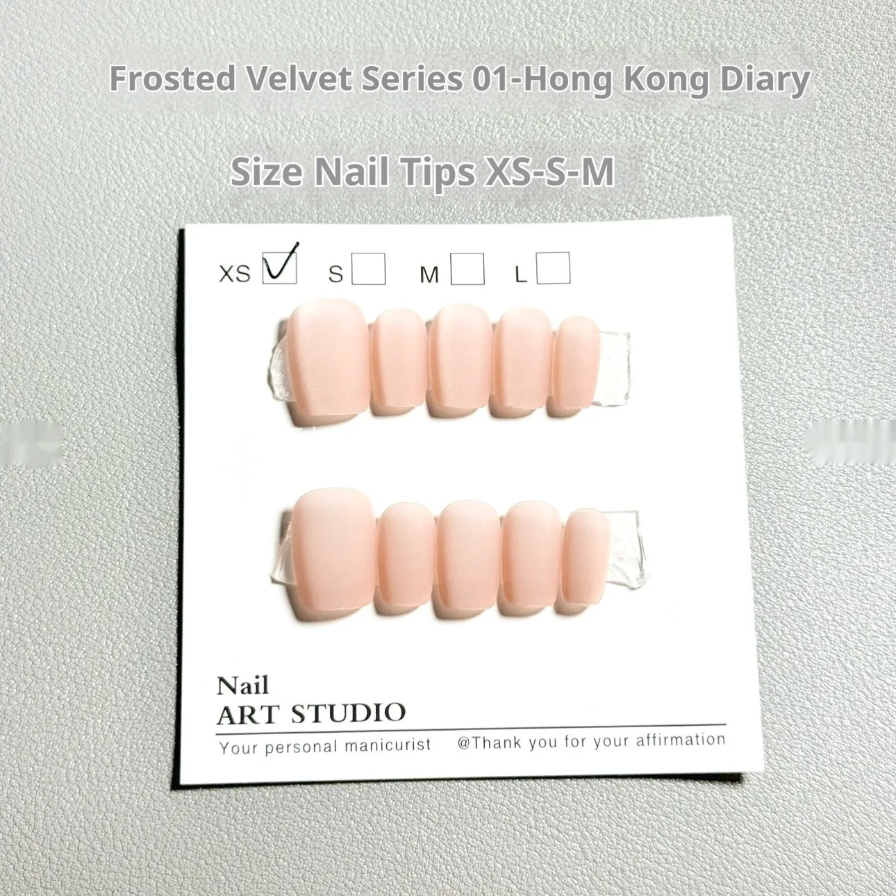 Set of false nails with frosted velvet finish and Cat's Eye designs in short ladder sizes XS, S, and M.