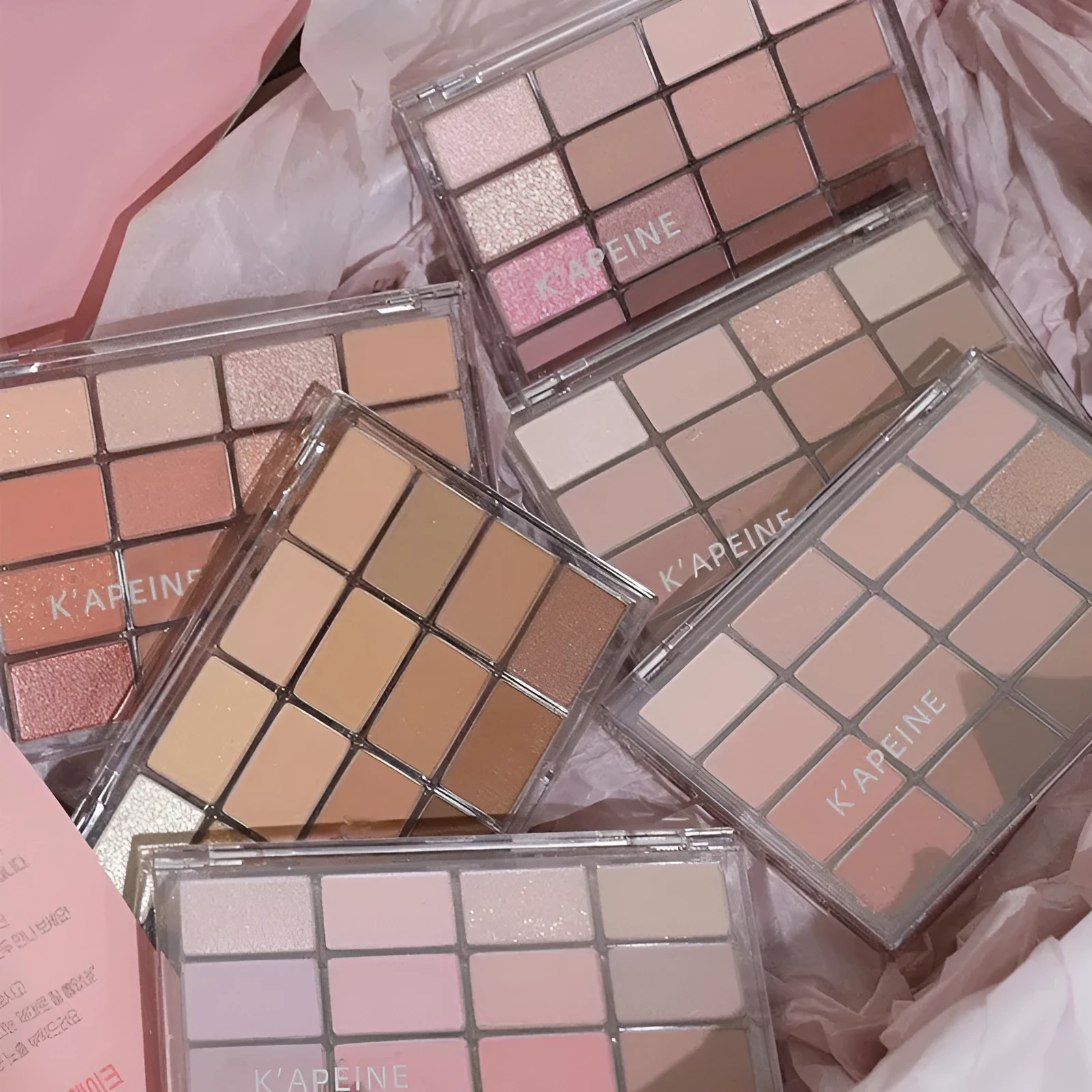 16 colour eyeshadow palette showing shimmer and matte shades in pink, brown and lavender colours