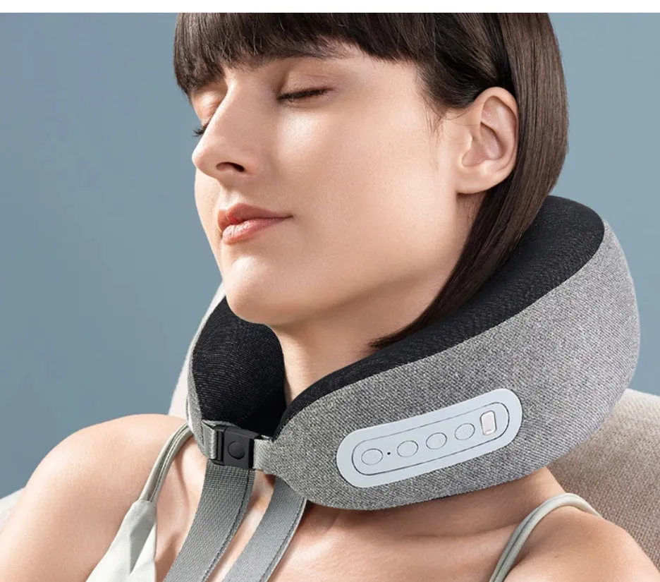Light grey U-shaped memory foam massage pillow with USB cable on a sofa for home neck and shoulder relief