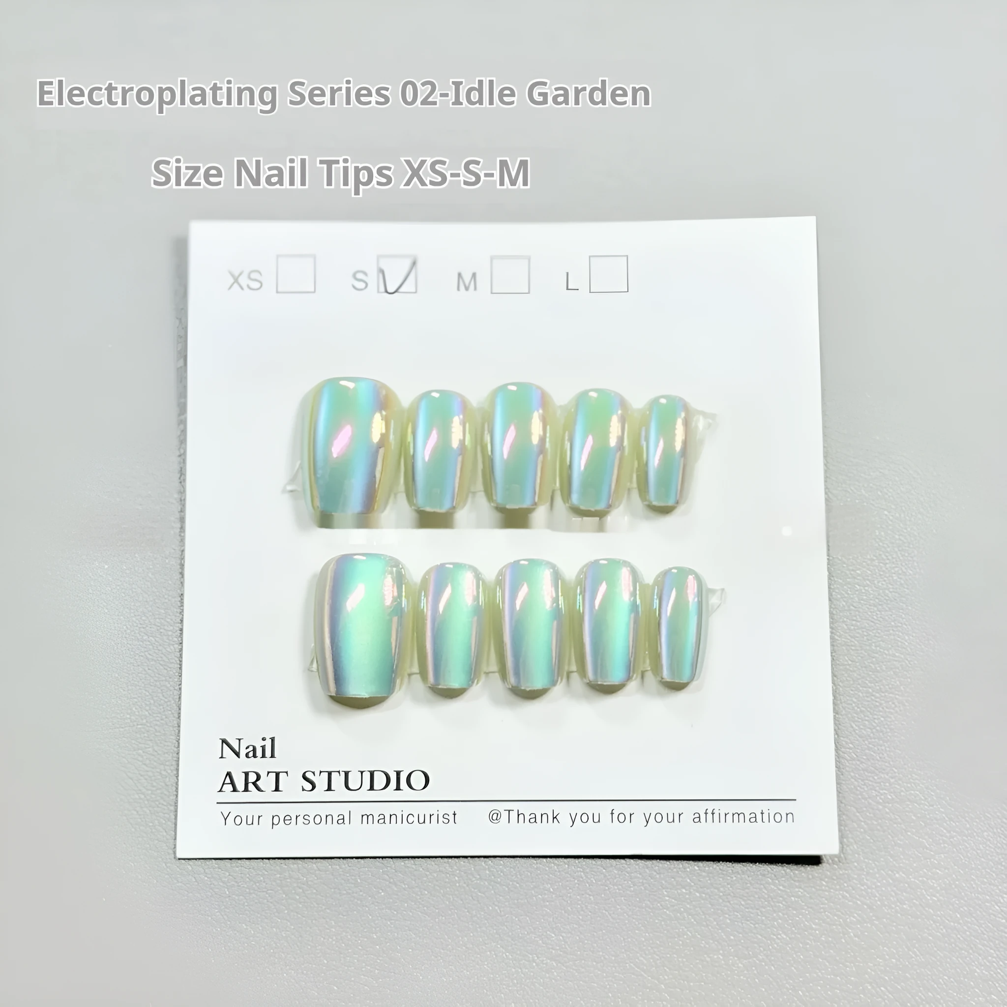 Electroplated Cat's Eye aurora effect false nail set in short ladder sizes on a display card.