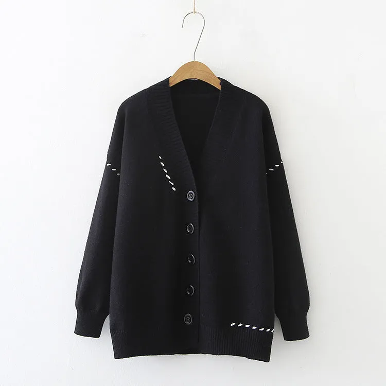 Women's loose-fitting knitted cardigan top coat in black, showing long sleeves and solid colour design.