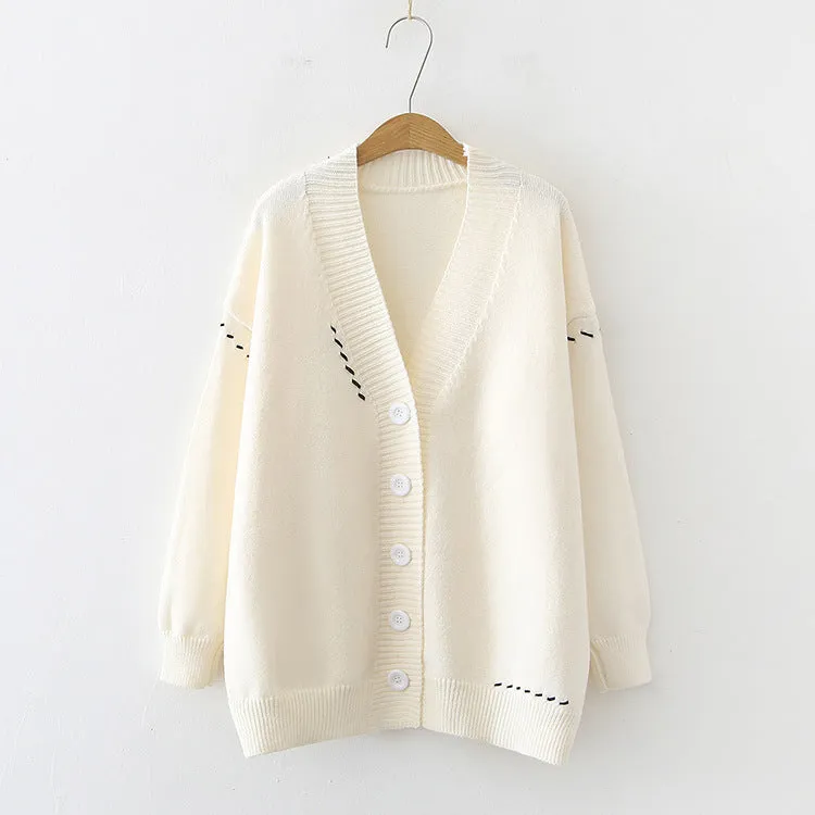 Women's loose-fitting knitted cardigan top coat in black, showing long sleeves and solid colour design.