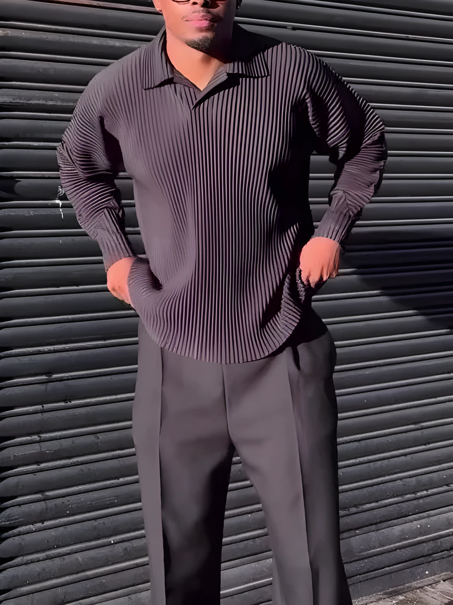 Men's black polyester long-sleeved top with pleated design detail showing regular fit and long sleeves