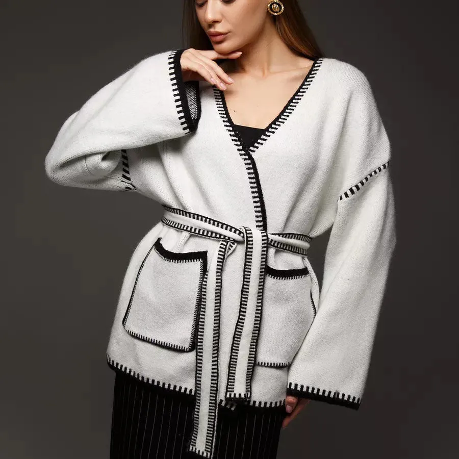 Loose mid-length knitted cardigan in camel colour on a hanger