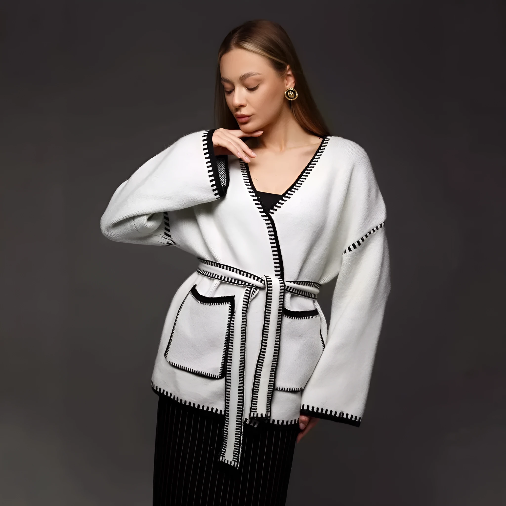 Loose mid-length knitted cardigan in camel colour on a hanger