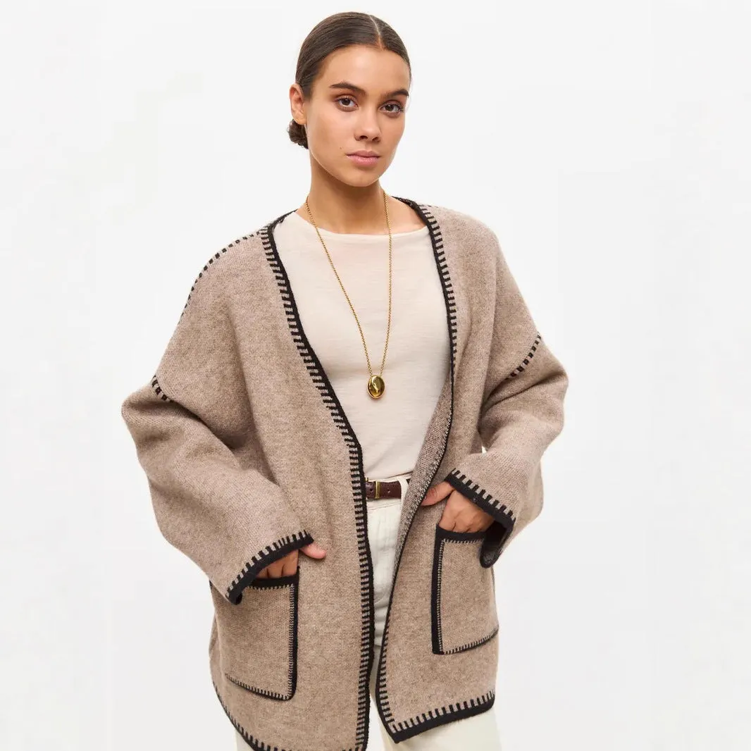 Loose mid-length knitted cardigan in camel colour on a hanger