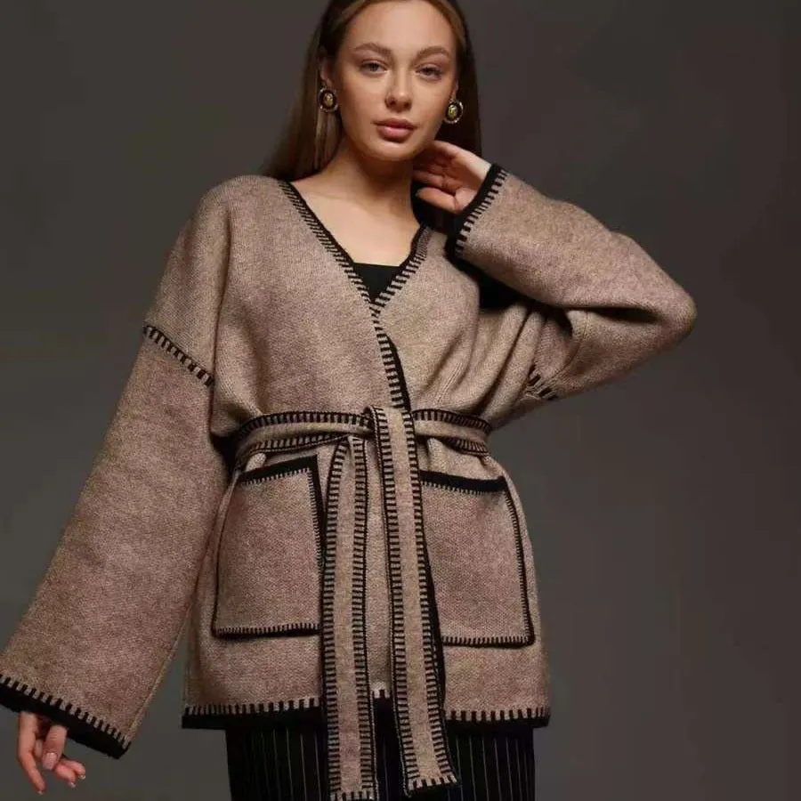Loose mid-length knitted cardigan in camel colour on a hanger