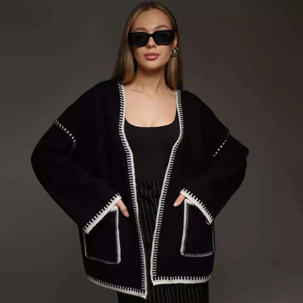 Loose mid-length knitted cardigan in camel colour on a hanger
