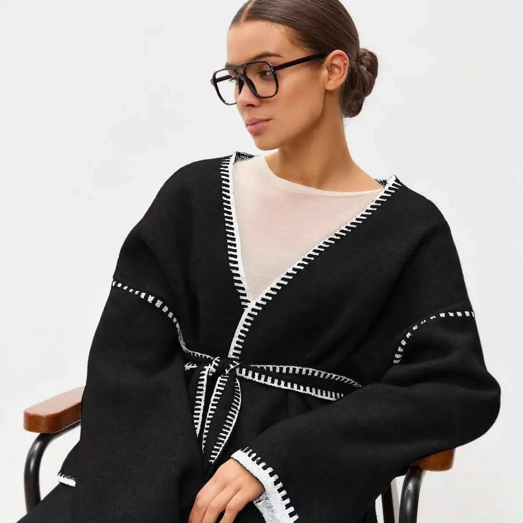 Loose mid-length knitted cardigan in camel colour on a hanger