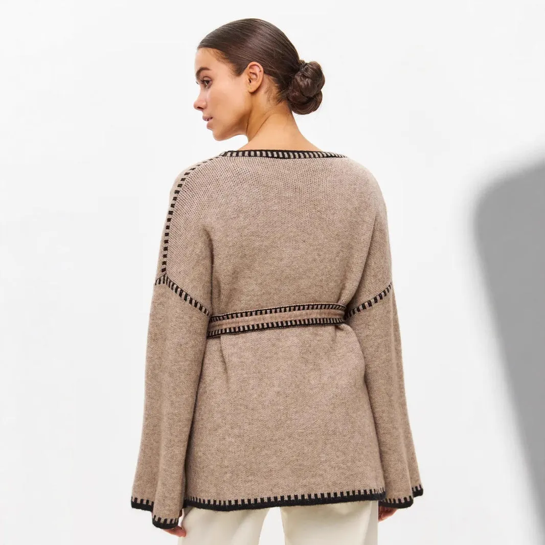 Loose mid-length knitted cardigan in camel colour on a hanger