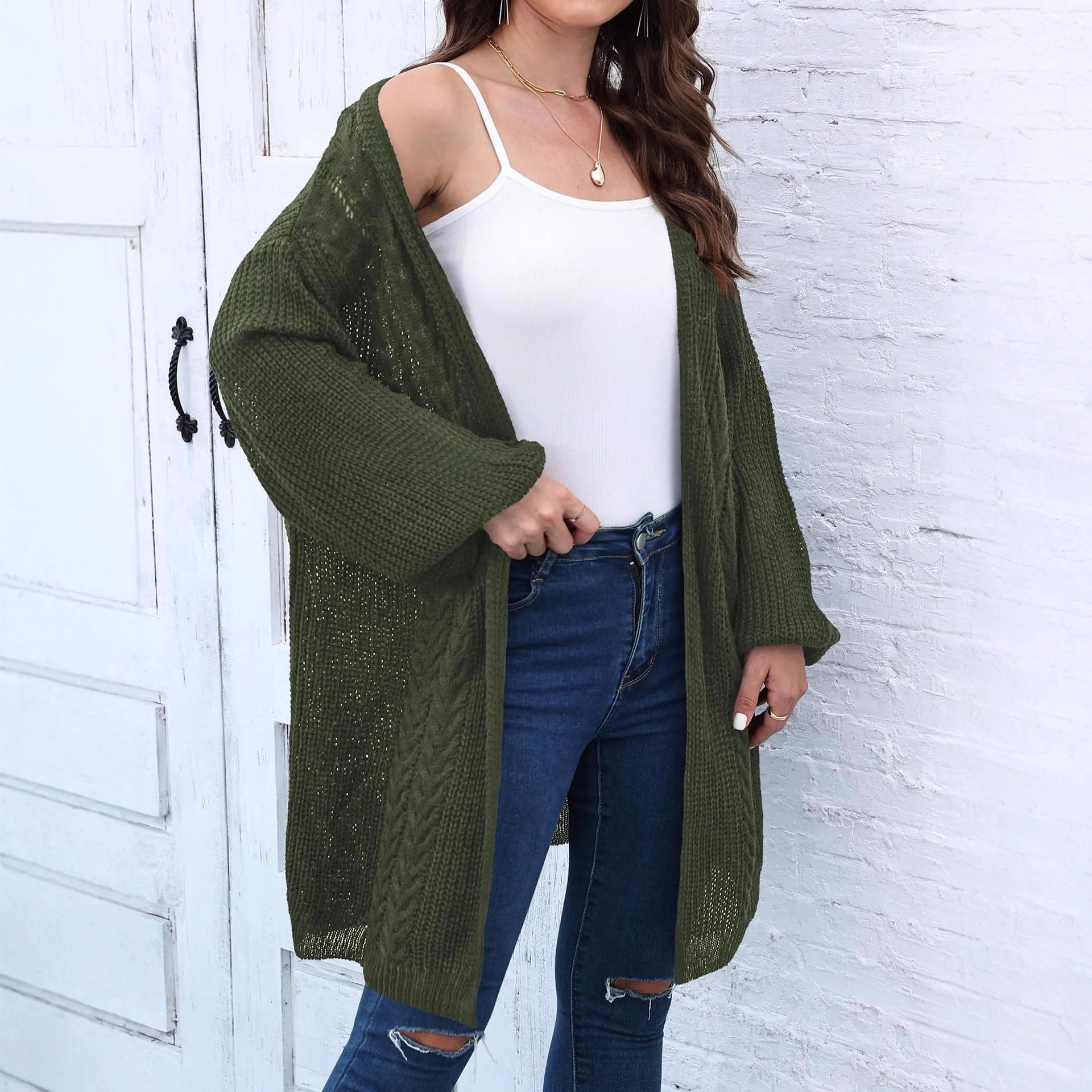 Women's loose acrylic sweater coat in a solid colour, shown in a casual style.