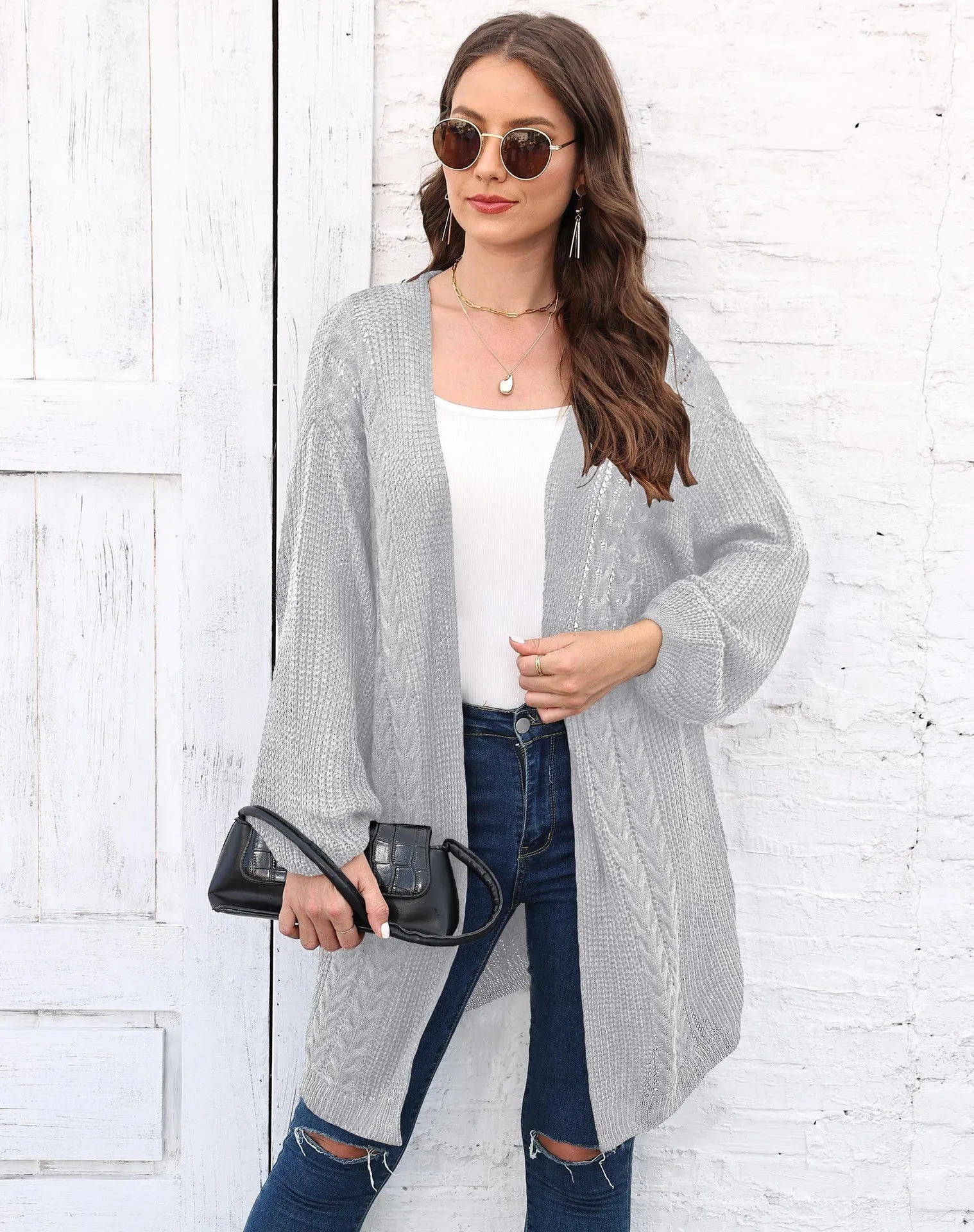 Women's loose acrylic sweater coat in a solid colour, shown in a casual style.
