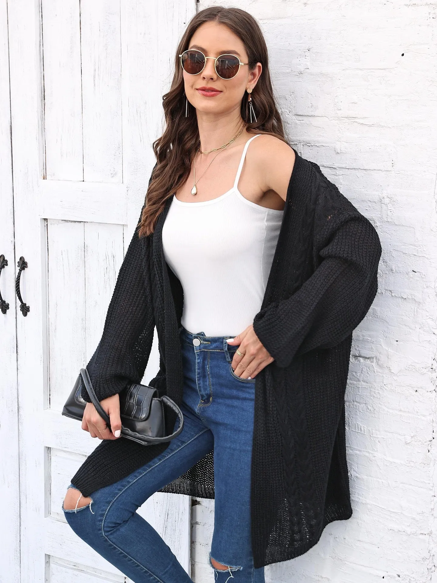 Women's loose acrylic sweater coat in a solid colour, shown in a casual style.