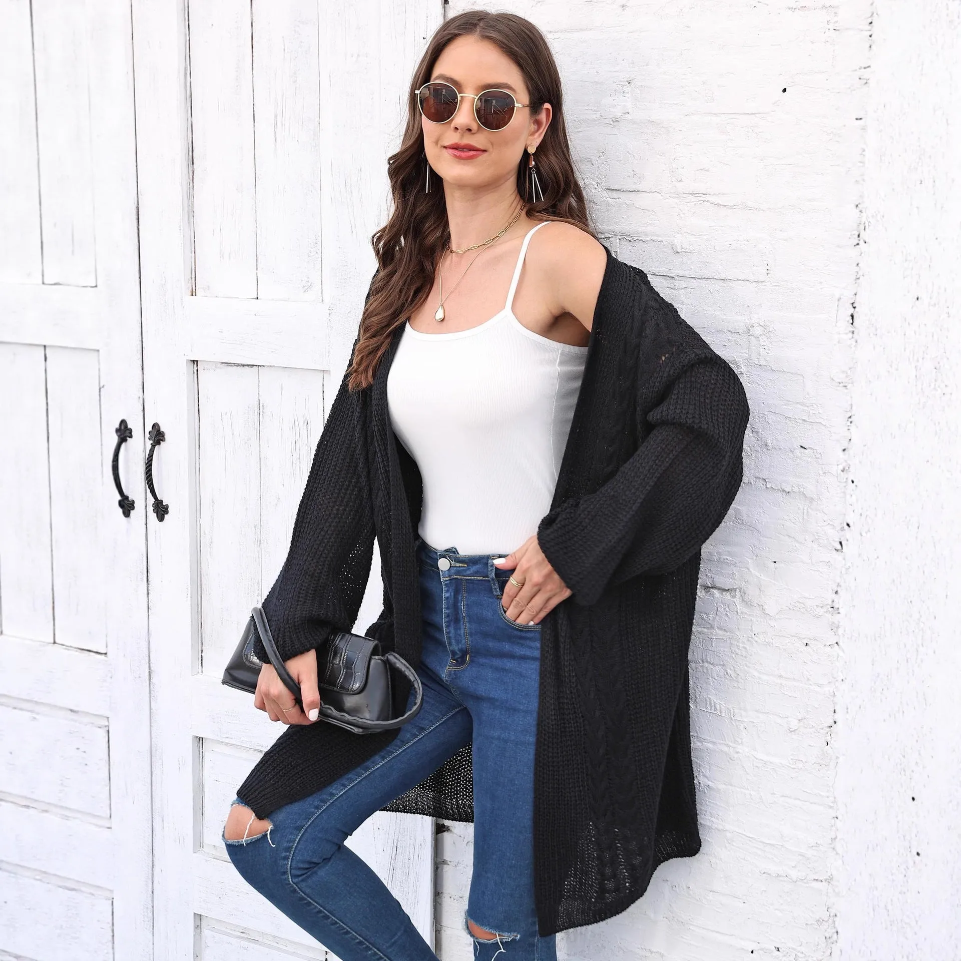 Women's loose acrylic sweater coat in a solid colour, shown in a casual style.