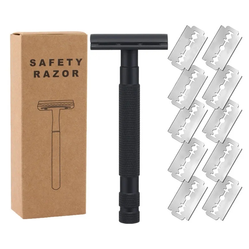 Old style manual double-sided alloy safety razor with replacement blades and cleaning brush on a table.