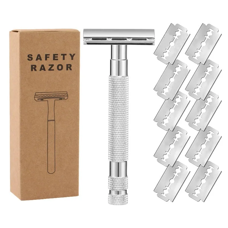 Old style manual double-sided alloy safety razor with replacement blades and cleaning brush on a table.