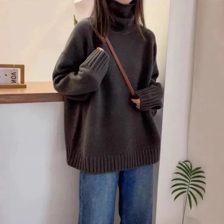 Women's loose grey turtleneck sweater with thick textured pile collar, casual style.