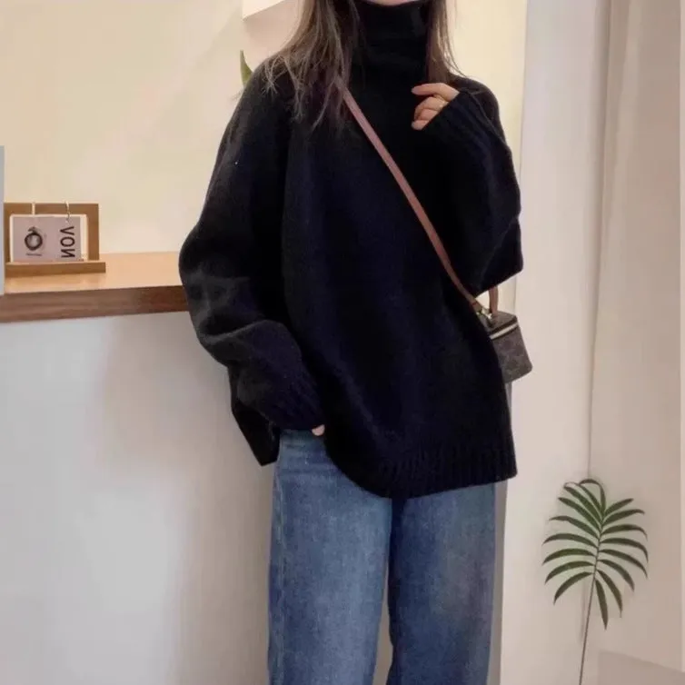 Women's loose grey turtleneck sweater with thick textured pile collar, casual style.