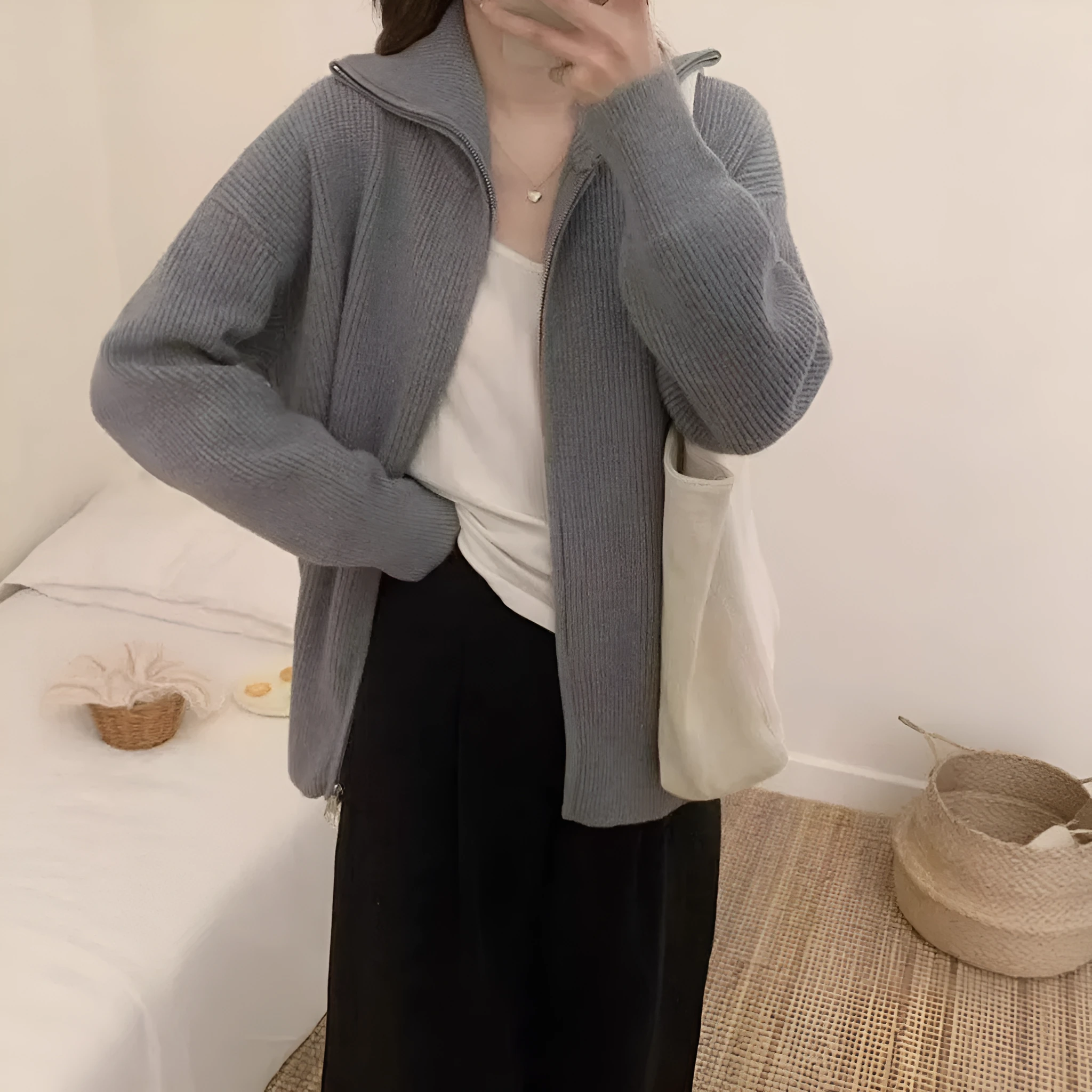 Grey Hong Kong style double zipper knitted cardigan with floral pattern on a hanger.