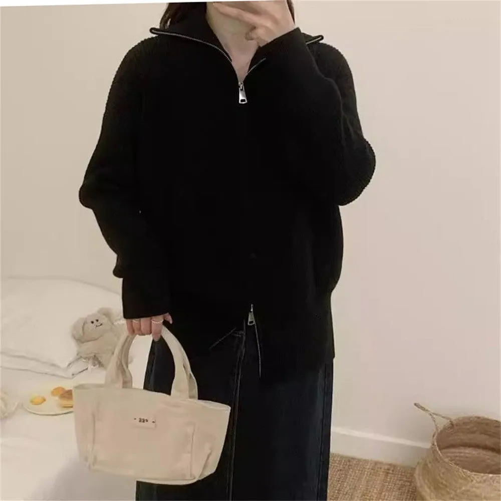 Grey Hong Kong style double zipper knitted cardigan with floral pattern on a hanger.
