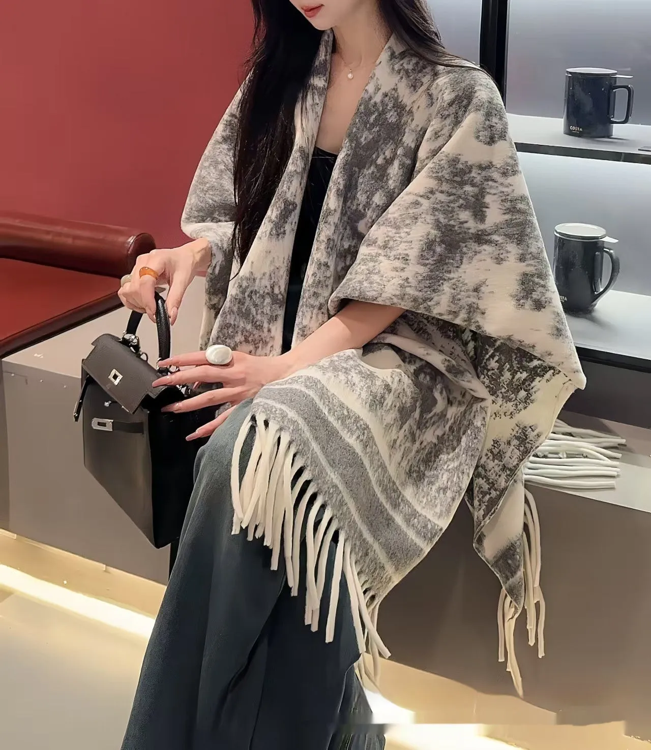 Women's tassel-trimmed polyester scarf cape worn as a shawl, shown in one of five available colours.