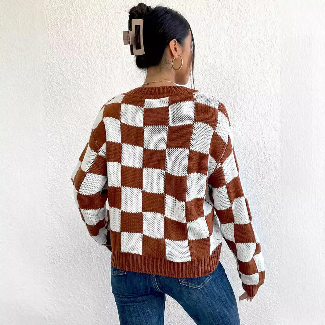 Dark brown plaid pattern long sleeve pullover sweater on a hanger.