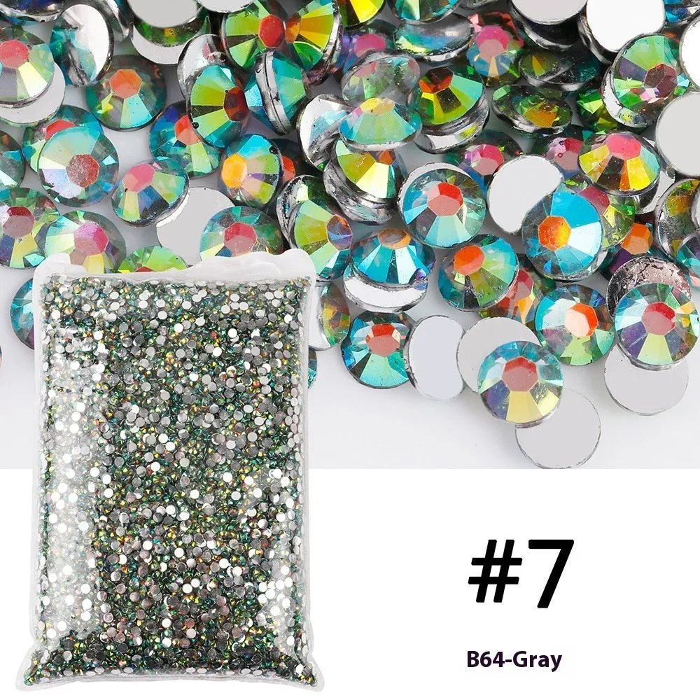 Assortment of multicoloured flat back resin rhinestones in various sizes for nail art and craft projects.