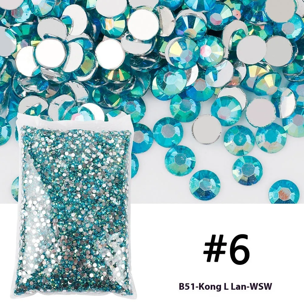 Assortment of multicoloured flat back resin rhinestones in various sizes for nail art and craft projects.