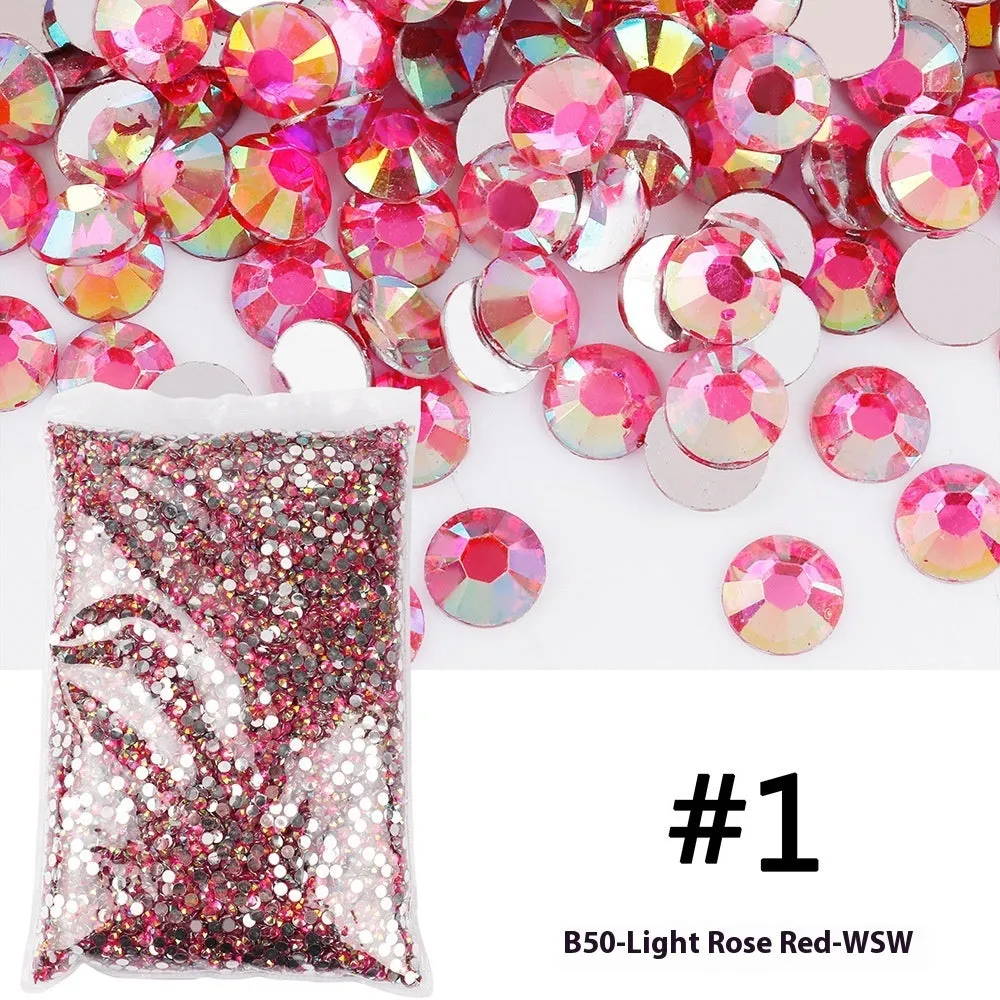 Assortment of multicoloured flat back resin rhinestones in various sizes for nail art and craft projects.
