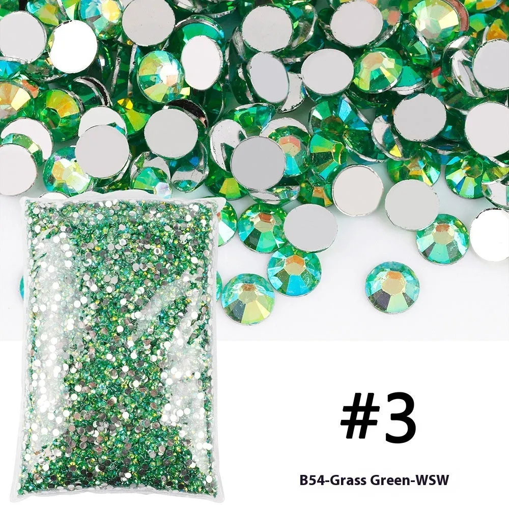 Assortment of multicoloured flat back resin rhinestones in various sizes for nail art and craft projects.