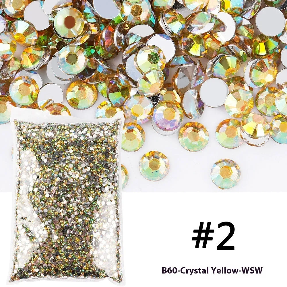 Assortment of multicoloured flat back resin rhinestones in various sizes for nail art and craft projects.