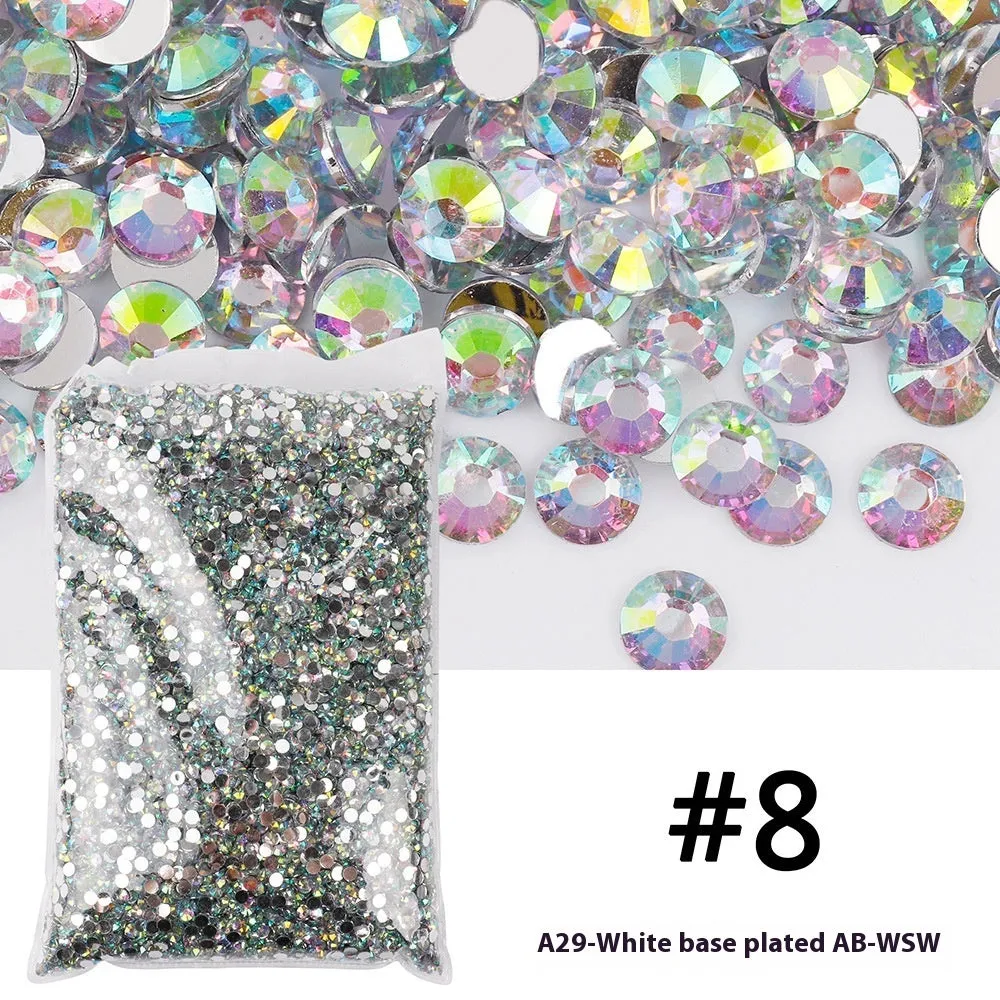 Assortment of multicoloured flat back resin rhinestones in various sizes for nail art and craft projects.
